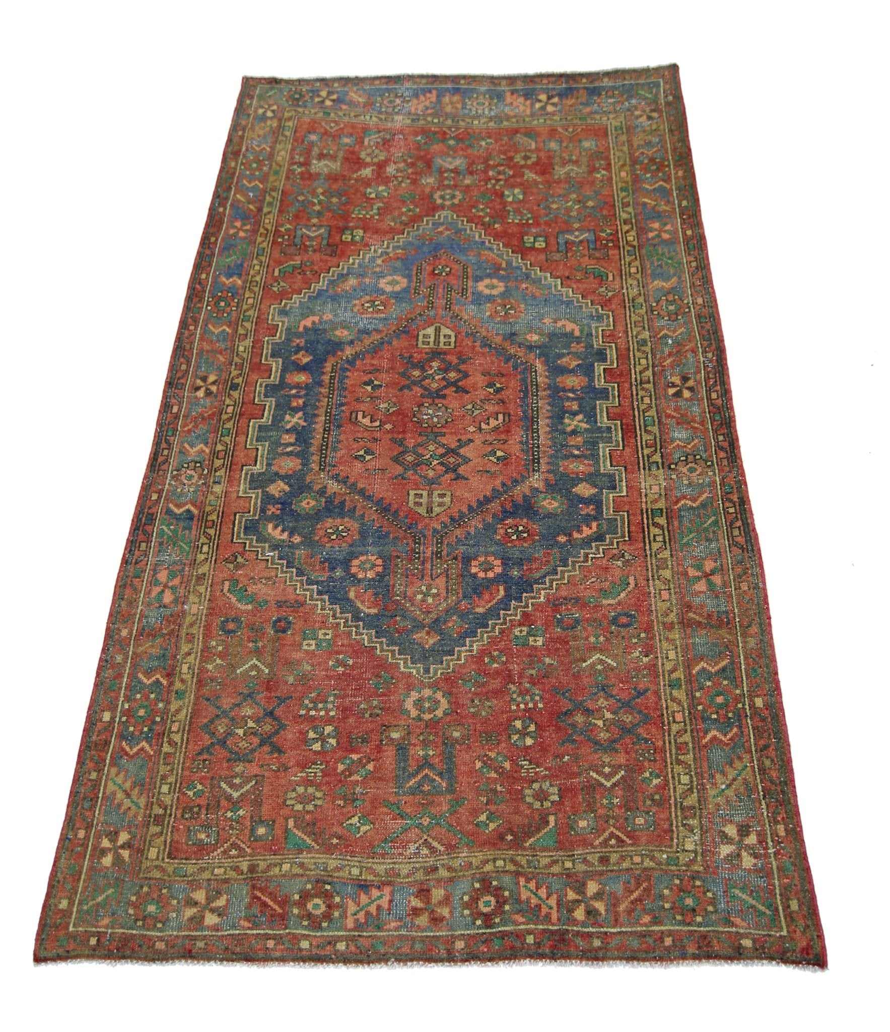 A vintage handmade Persian Hamadan rug featuring a central blue medallion on a red field.
