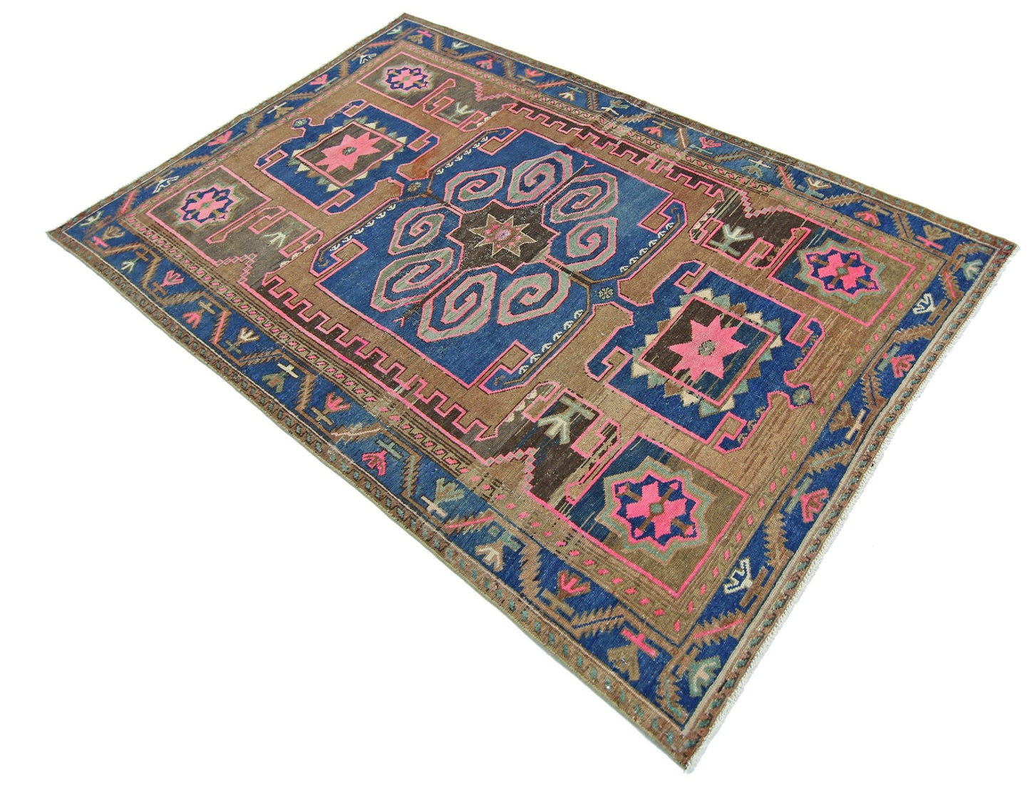 A vintage Persian Hamadan rug featuring a geometric floral pattern in blue, brown, and pink.