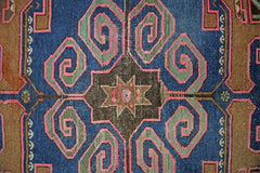 A vintage Persian Hamadan rug featuring a central geometric star motif in brown, blue, and pink.