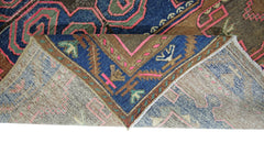 A vintage Persian Hamadan rug featuring a geometric pattern in blue, brown, and pink wool.