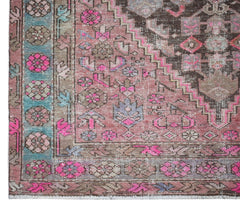 A vintage Persian Hamadan rug featuring a geometric pattern in shades of pink, brown, and blue.