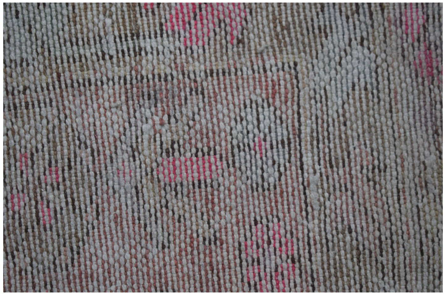 A close-up view of a vintage Persian Hamadan rug featuring faded floral patterns in wool.