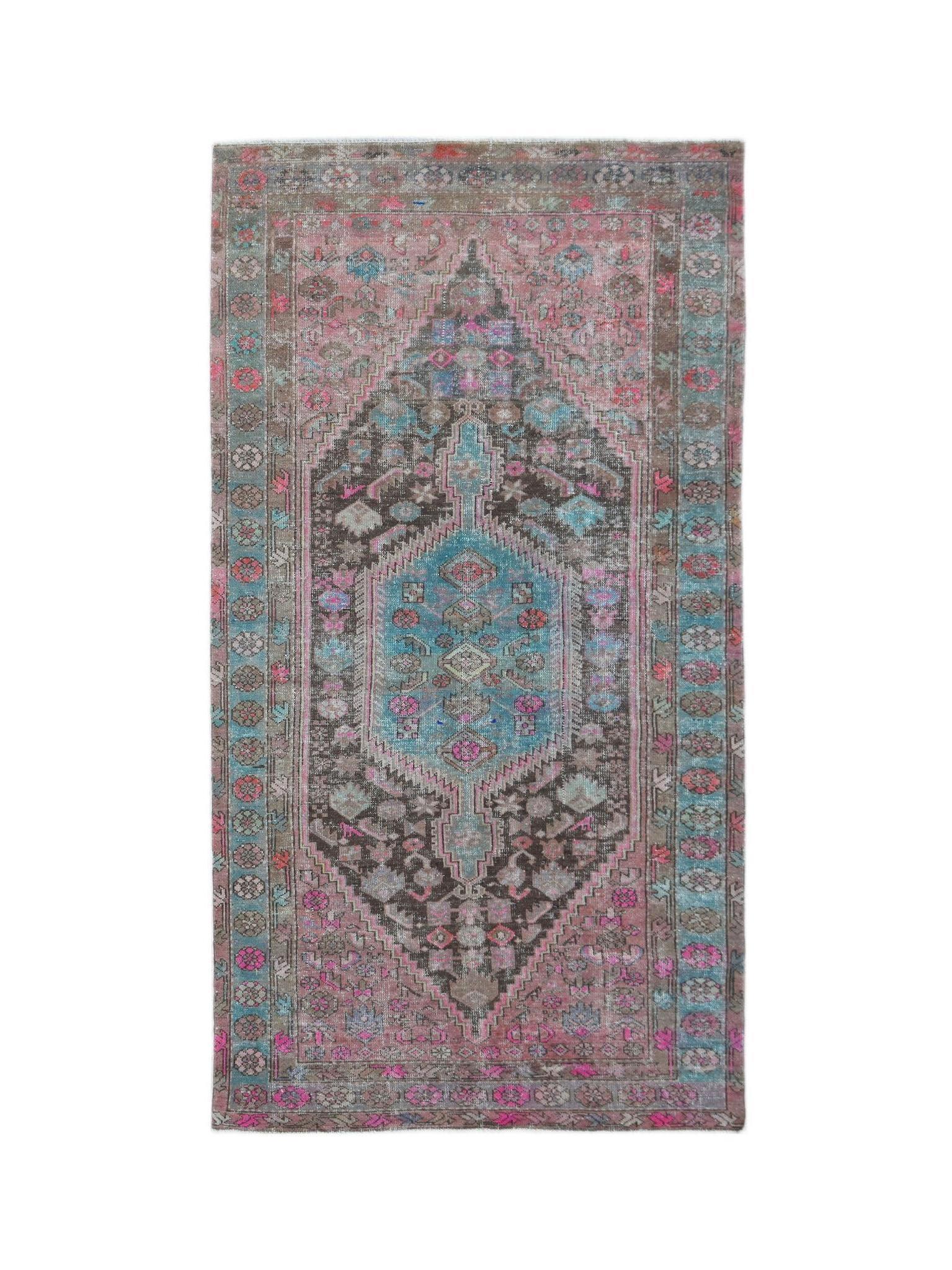 A vintage handwoven Persian Hamadan rug featuring a central medallion in shades of pink and blue.