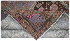 Vintage Persian Hamadan rug with brown, purple, and pink geometric patterns.