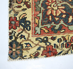 A close-up of a vintage Persian rug featuring intricate floral patterns in red, blue, and cream.
