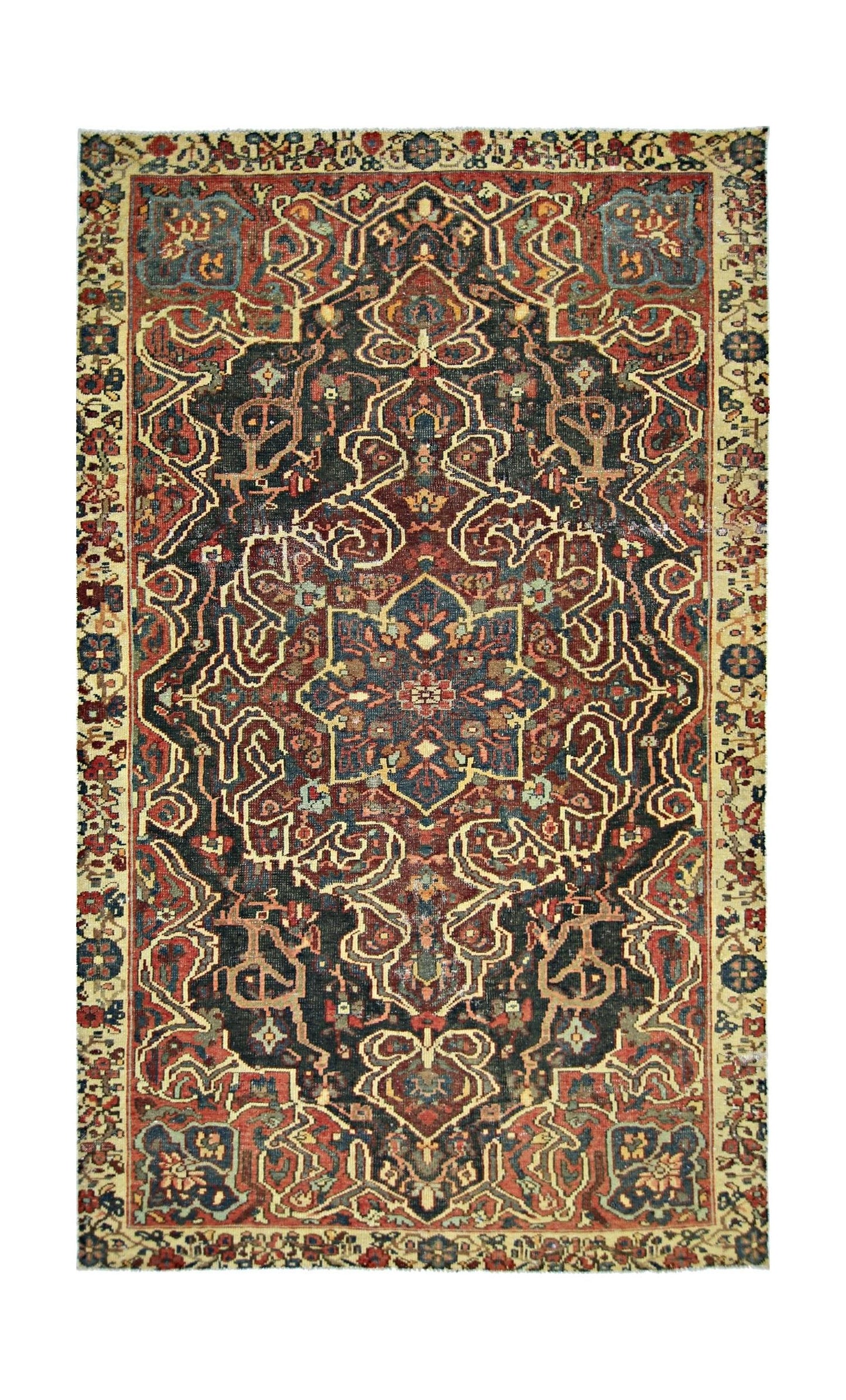 A vintage handmade Persian rug featuring a central floral medallion on a dark patterned field.