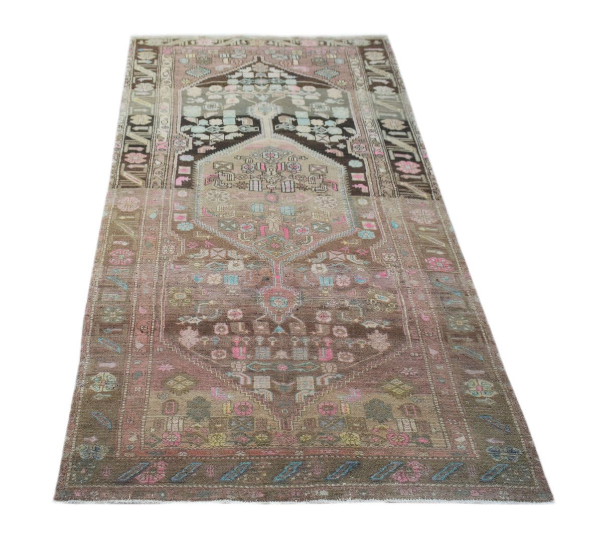 A vintage handwoven Persian Hamadan rug featuring a faded brown and pink geometric pattern.