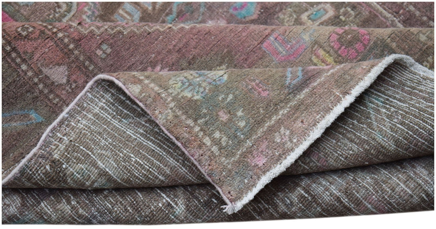 A vintage handwoven Persian Hamadan rug featuring a faded brown pattern with pink and blue accents.
