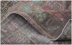 A vintage handwoven Persian Hamadan rug with a worn, faded floral pattern in pink and blue tones.