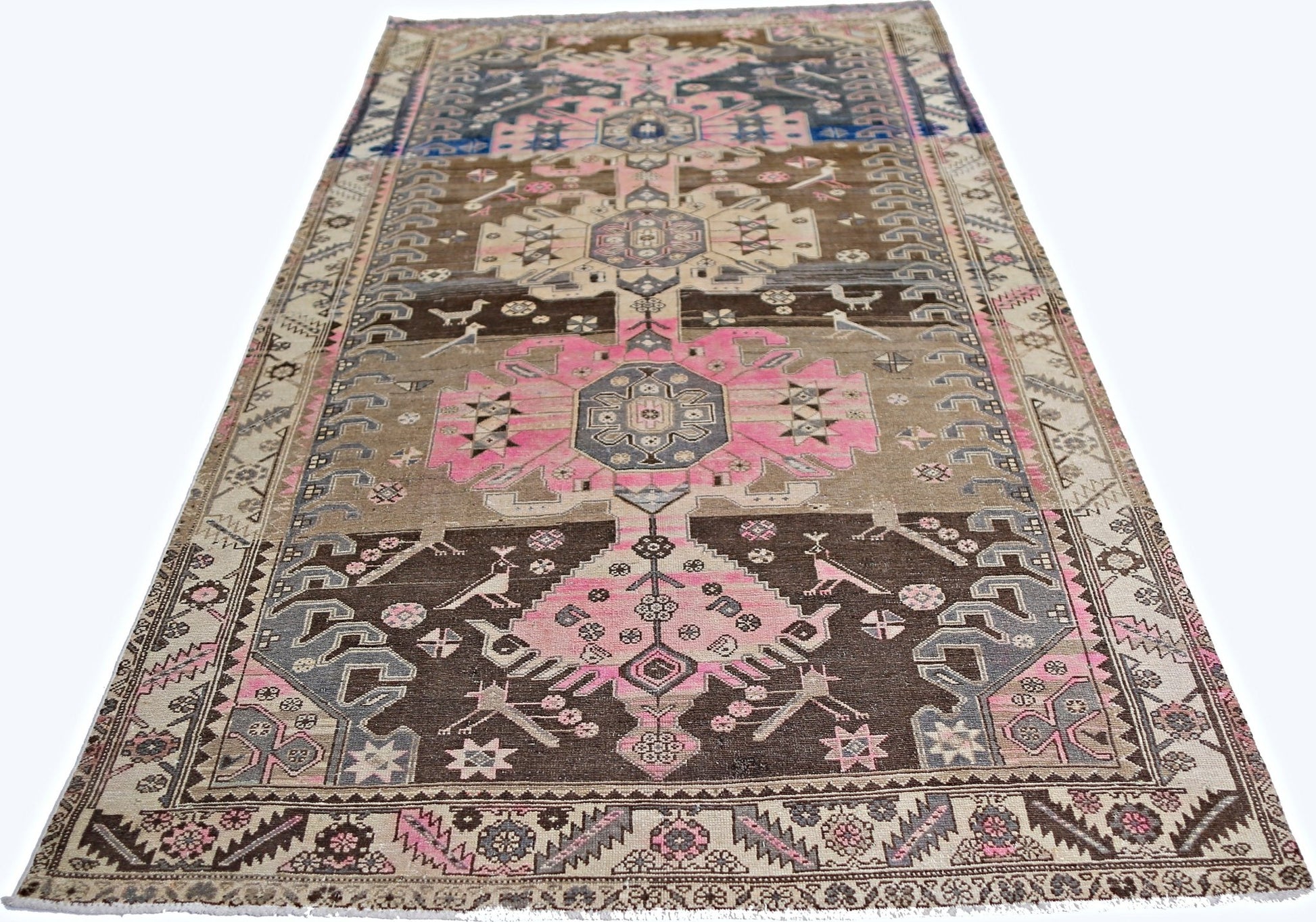 A vintage Persian Hamadan rug featuring geometric floral motifs in pink, brown, and grey tones.