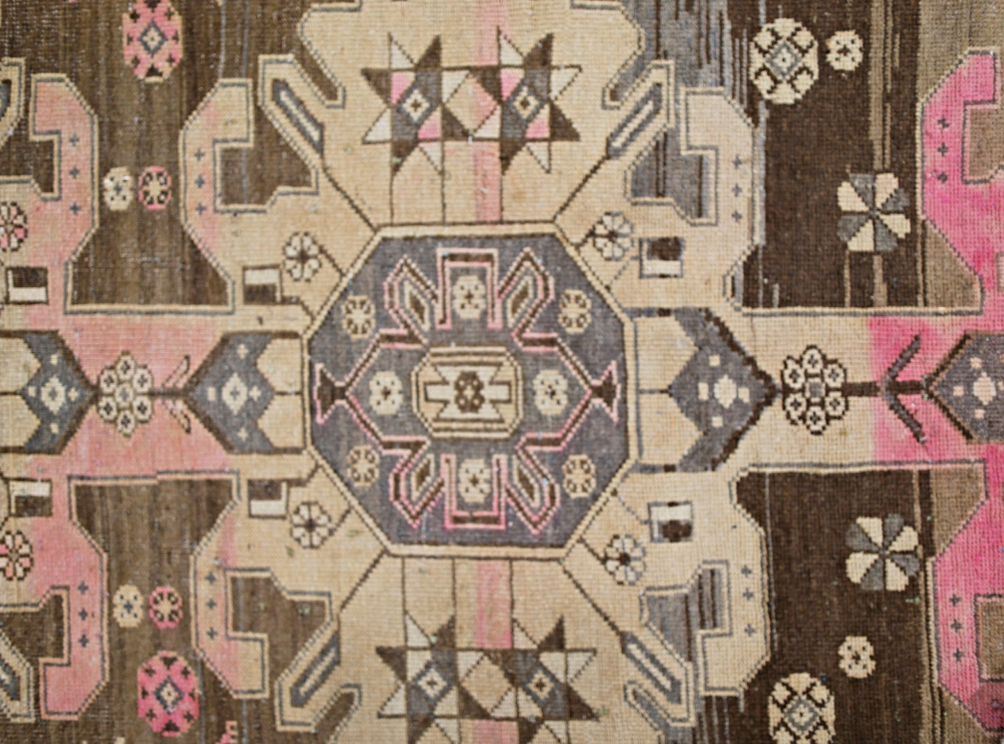 A vintage Persian Hamadan rug featuring a geometric medallion pattern in brown, beige, and pink.