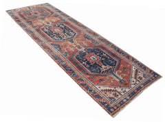 A vintage Persian Hamadan runner rug featuring a geometric pattern in red and blue tones.