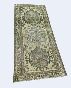 A vintage handmade Persian Hamadan runner rug featuring geometric patterns in muted earth tones.