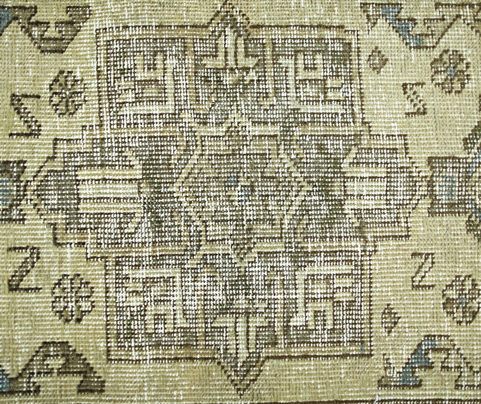 A vintage Persian Hamadan rug featuring a geometric central medallion in muted earth tones.
