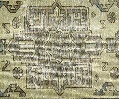 A vintage Persian Hamadan rug featuring a geometric central medallion in muted earth tones.