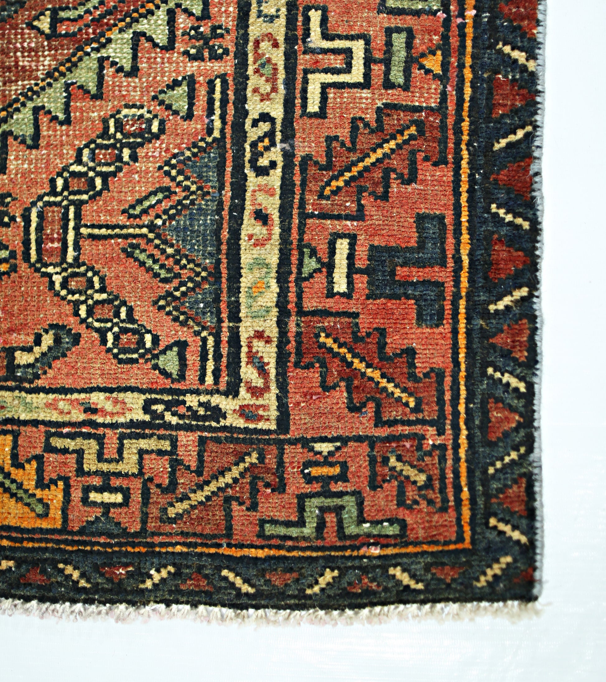 A vintage Persian Hamadan runner featuring geometric patterns in red, blue, and cream wool.