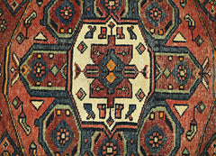 A vintage Persian Hamadan runner featuring a geometric medallion pattern in red, blue, and cream.