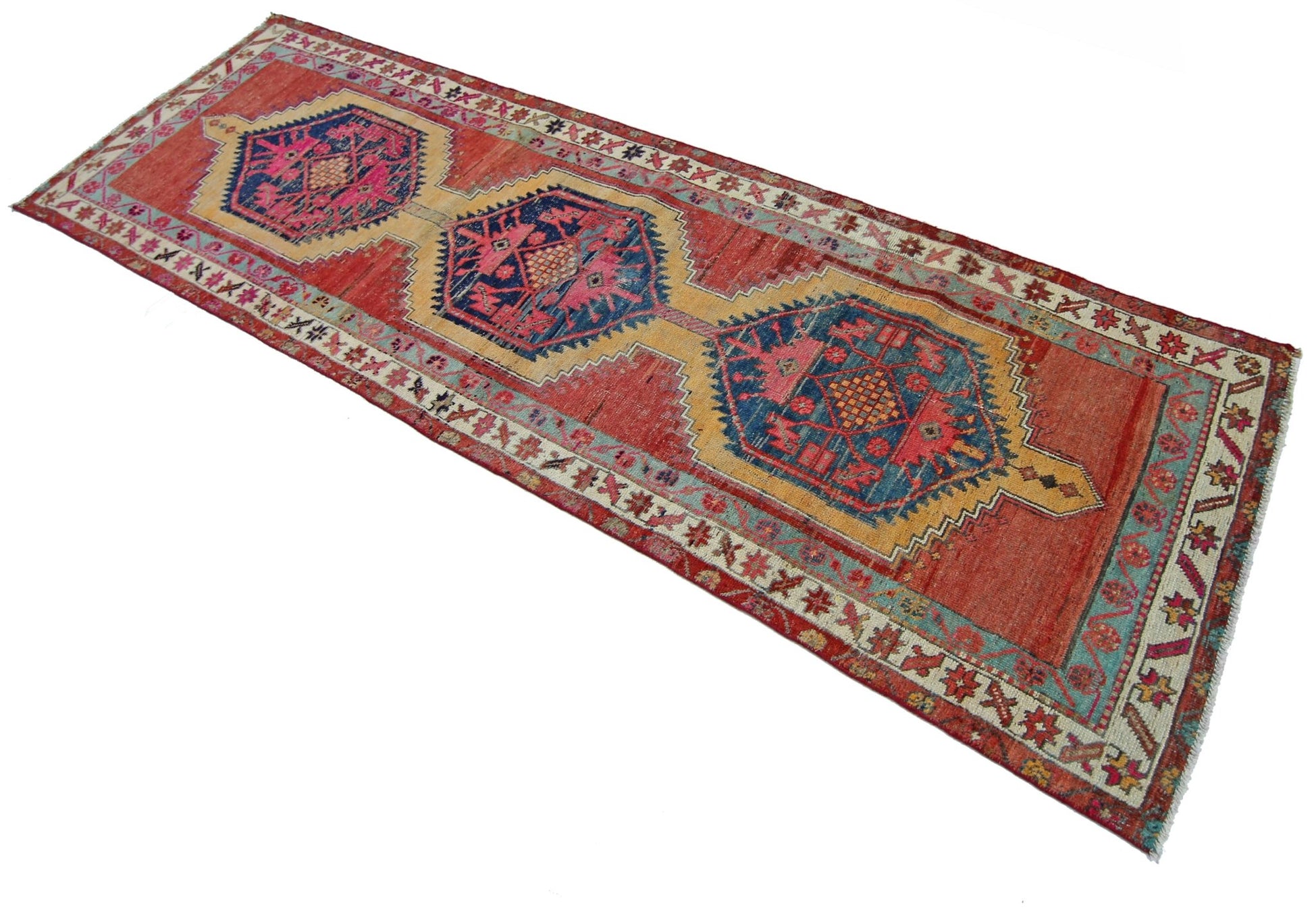 A vintage Persian Hamadan runner featuring three blue and pink geometric medallions on a red field.