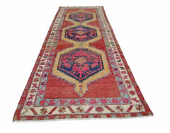 A vintage Persian Hamadan runner featuring three geometric medallions on a red wool field.