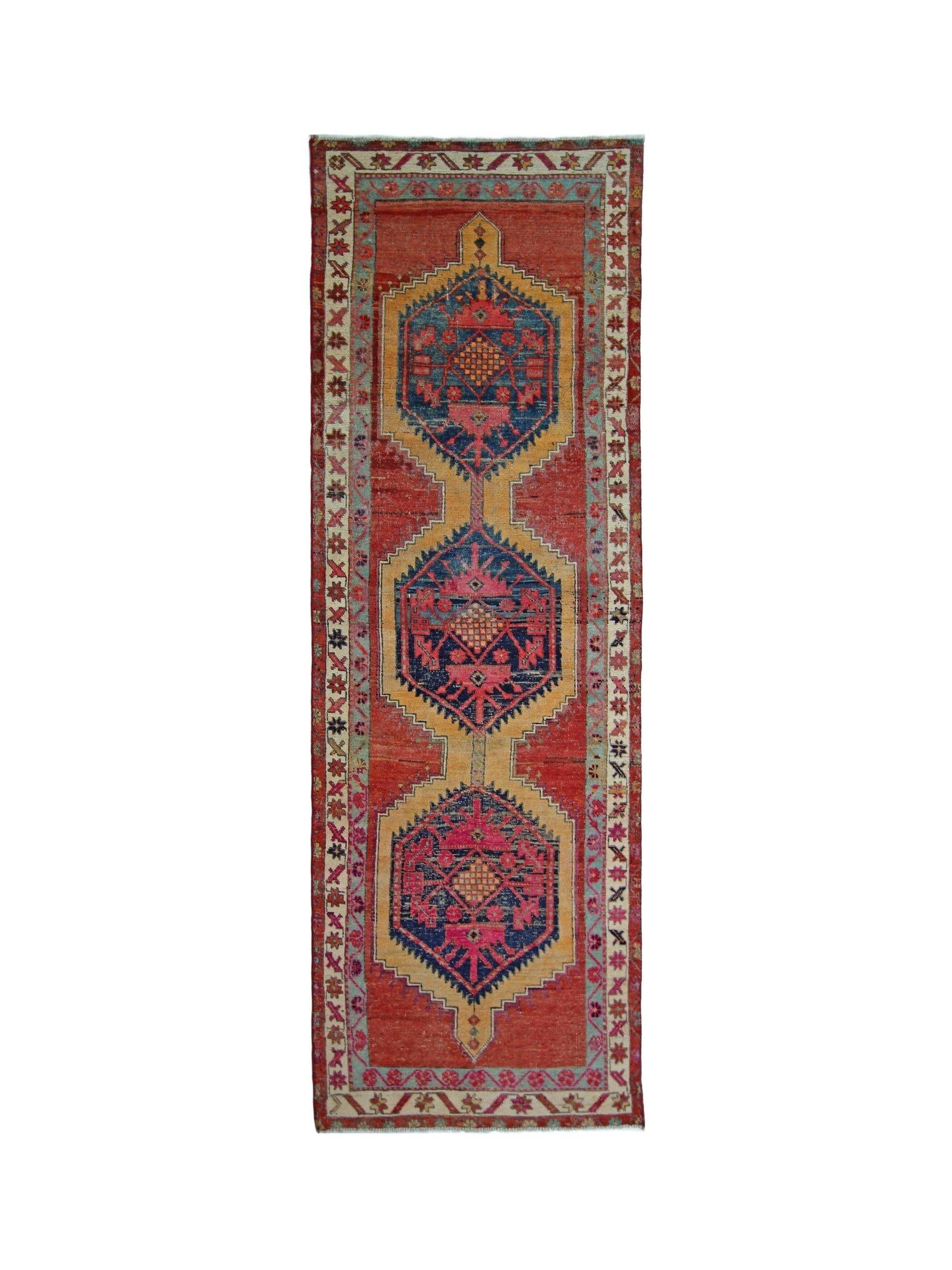 A vintage Persian Hamadan runner featuring three geometric medallions in red, blue, and gold.