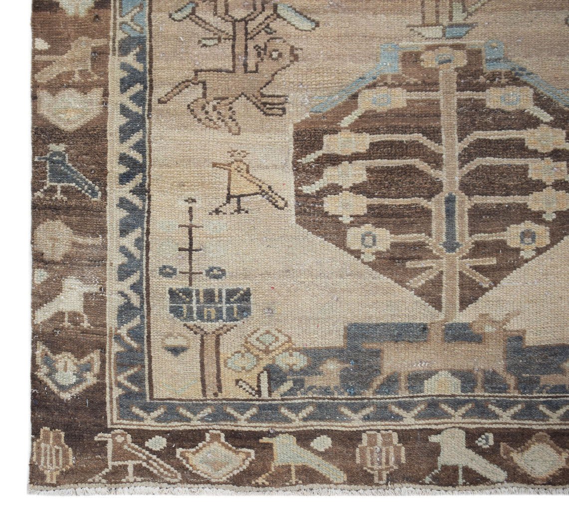 A vintage handwoven Persian Hamadan runner featuring a beige field with brown tree and bird motifs.