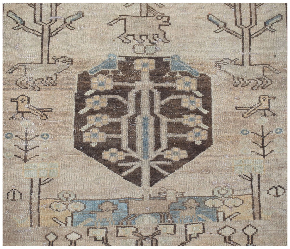 A vintage handwoven Persian Hamadan runner featuring a central tree motif surrounded by animals.