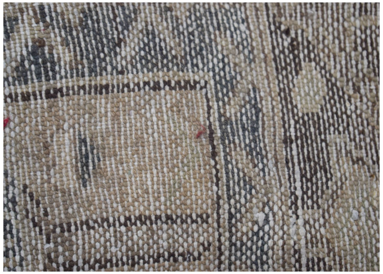 A close-up view of a vintage Persian Hamadan runner featuring intricate woven wool patterns.