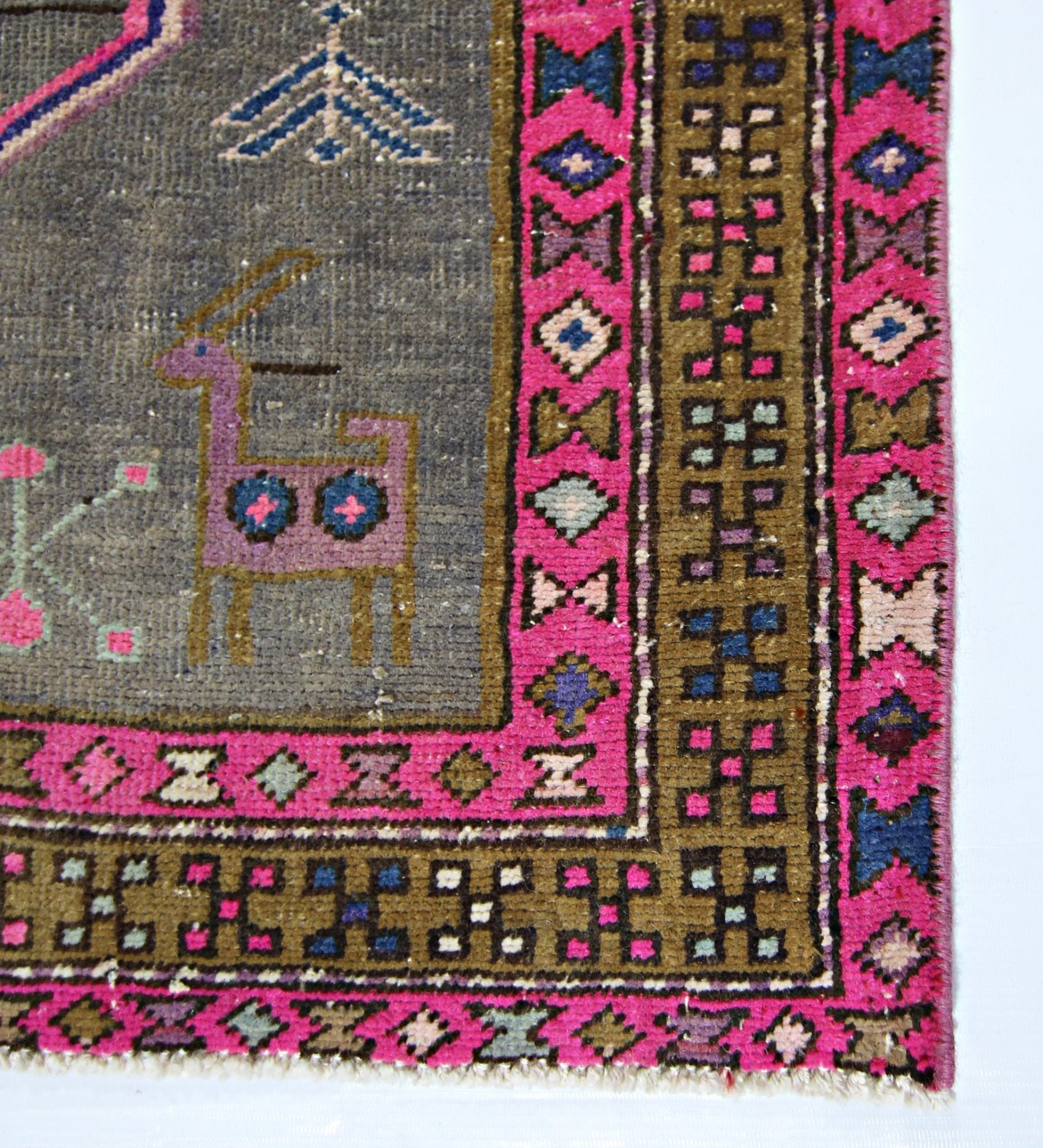 A vintage Persian Hamadan runner featuring a grey field with a stylized animal and pink borders.