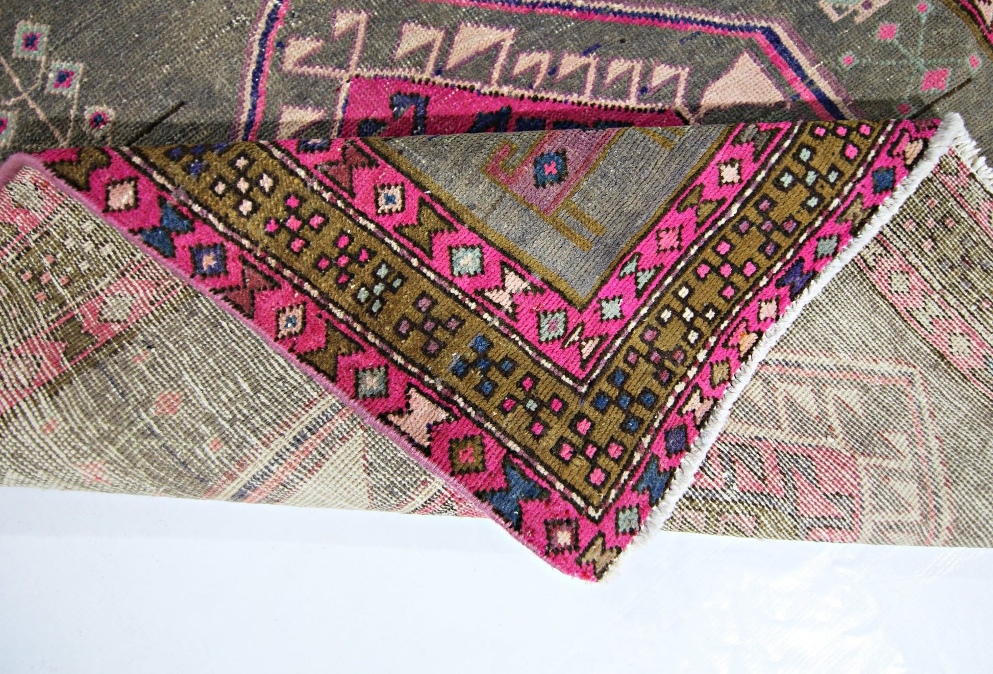 A vintage Persian Hamadan runner featuring a geometric pattern in vibrant pink, olive, and grey.