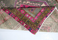 A vintage Persian Hamadan runner featuring a geometric pattern in vibrant pink, olive, and grey.