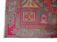A vintage Persian Hamadan runner featuring geometric patterns in pink, green, and brown wool.