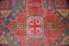 A vintage Persian Hamadan runner featuring a geometric pattern in red, blue, and cream tones.
