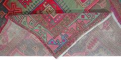 A vintage Persian Hamadan runner featuring a geometric pattern in vibrant pink, green, and blue.