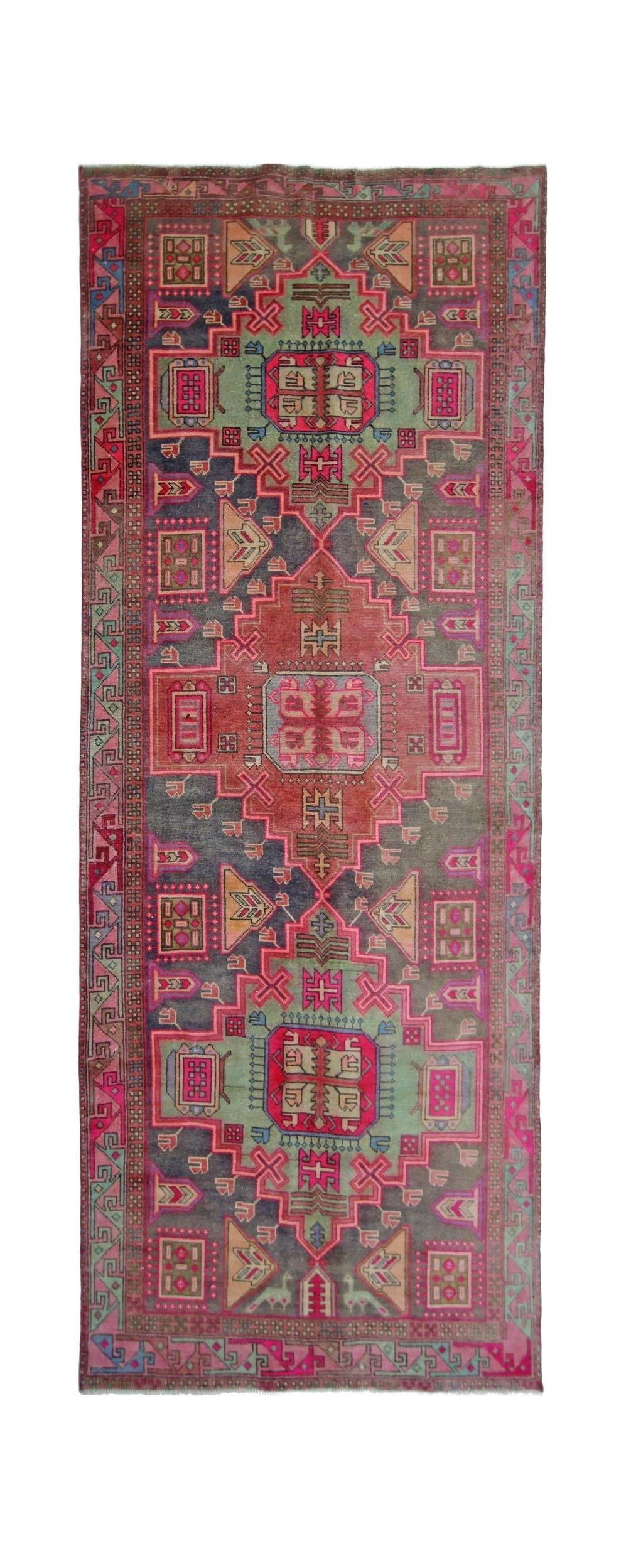 A vintage Persian Hamadan runner featuring a geometric pattern in vibrant pink, green, and grey.