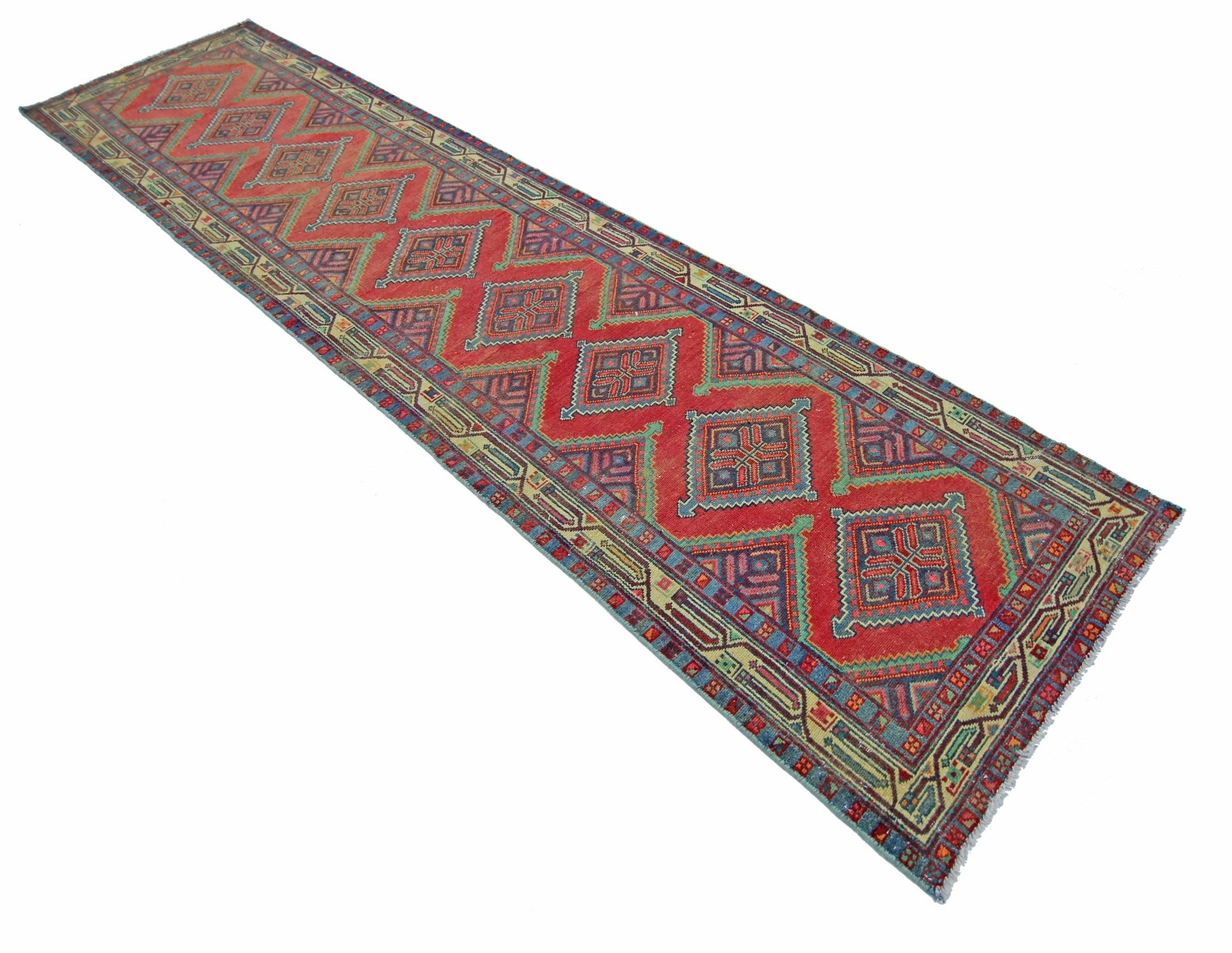 A vintage Persian Hamadan runner featuring a red field with repeating geometric diamond motifs.