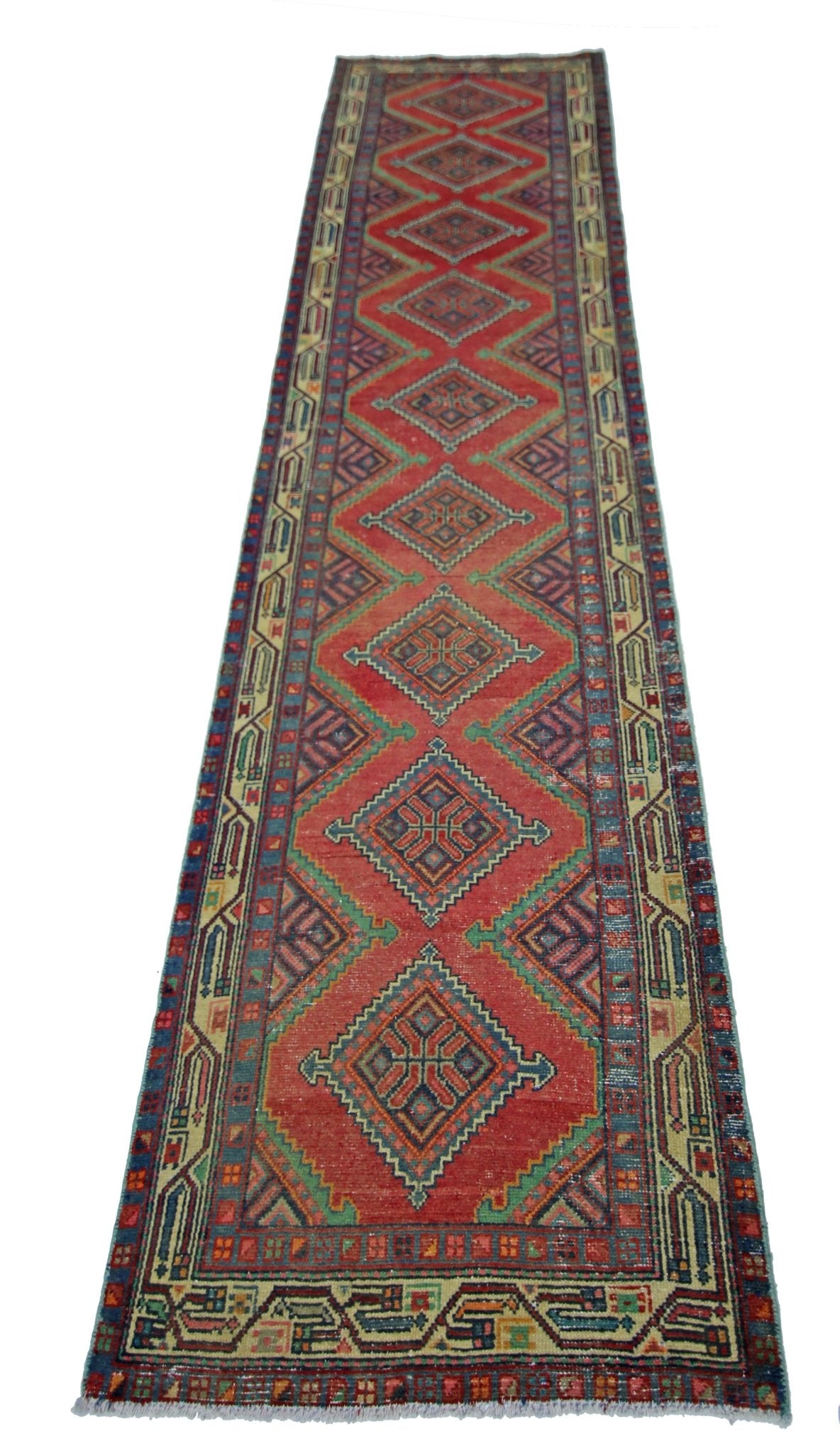A vintage Persian Hamadan runner rug featuring a red field with repeating diamond medallions.
