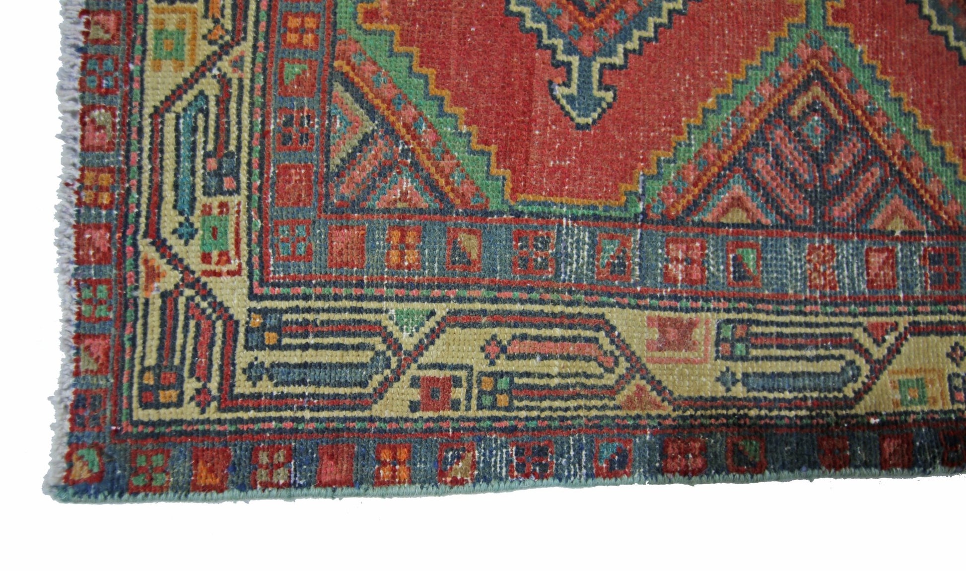 A vintage Persian Hamadan runner featuring a geometric red, blue, and green patterned border.