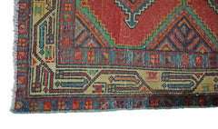 A vintage Persian Hamadan runner featuring a geometric red, blue, and green patterned border.