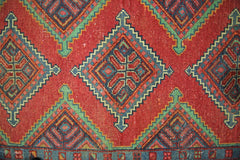 A vintage Persian Hamadan runner featuring a repeating geometric diamond pattern in red and blue.
