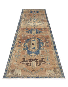 A vintage Persian Hamadan runner rug featuring geometric blue and brown tribal patterns.