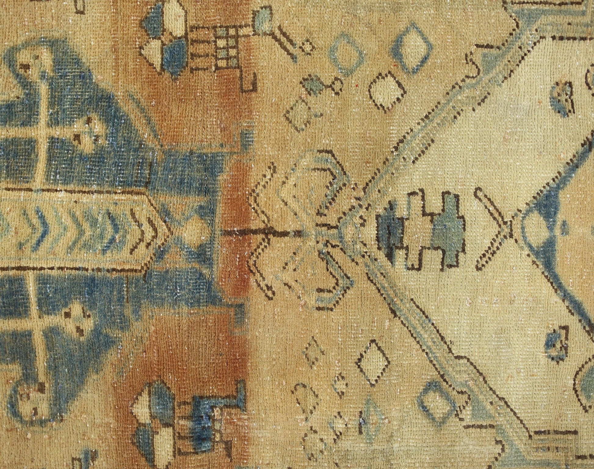 A vintage Persian Hamadan runner featuring geometric tribal patterns in blue and tan wool.