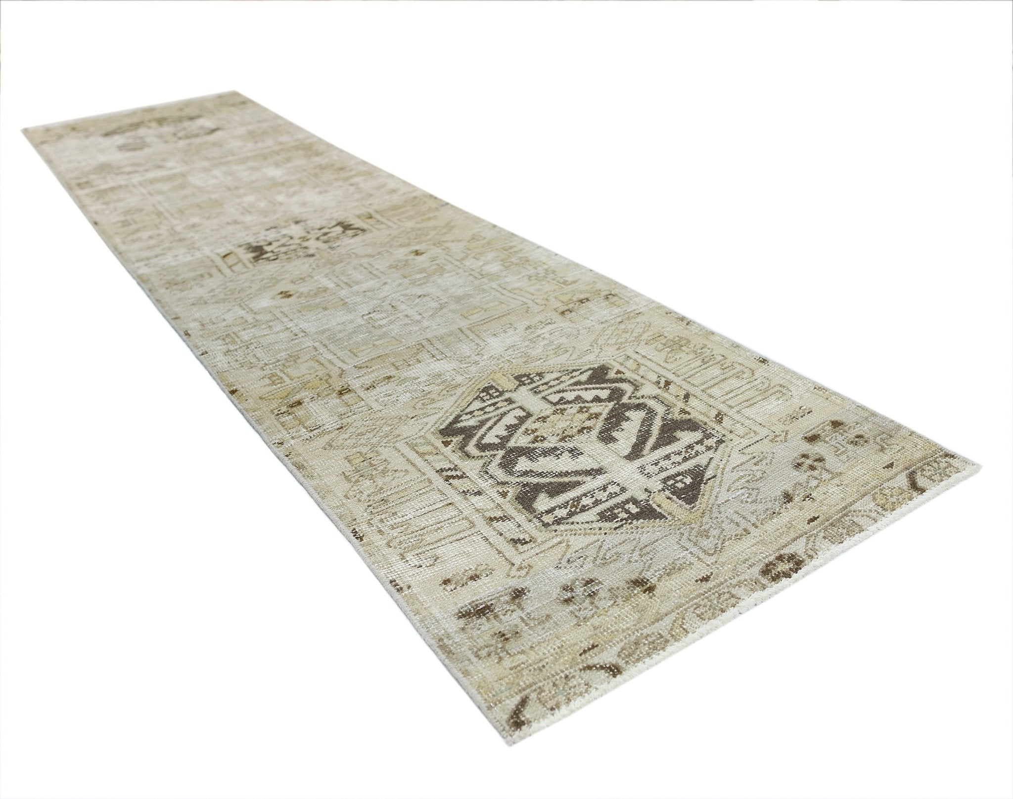 A vintage Persian Hamadan runner rug featuring a faded geometric pattern in neutral beige tones.