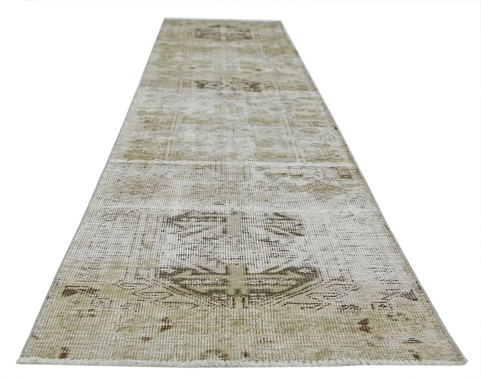 A vintage Persian Hamadan runner rug featuring a faded geometric pattern in neutral beige tones.