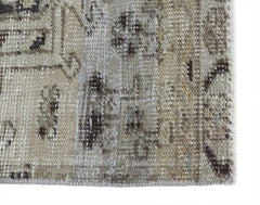 A close-up of a vintage Persian Hamadan runner featuring a faded, distressed wool pattern.