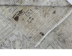 A vintage Persian Hamadan runner with a distressed beige and brown geometric pattern.
