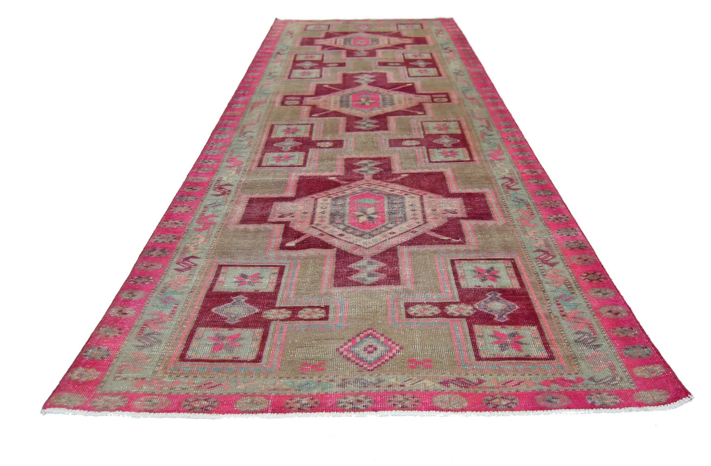 A vintage Persian Hamadan runner featuring geometric patterns in shades of pink and beige.
