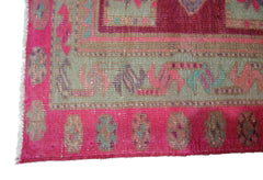 A vintage Persian Hamadan runner featuring a vibrant pink border with geometric patterns.