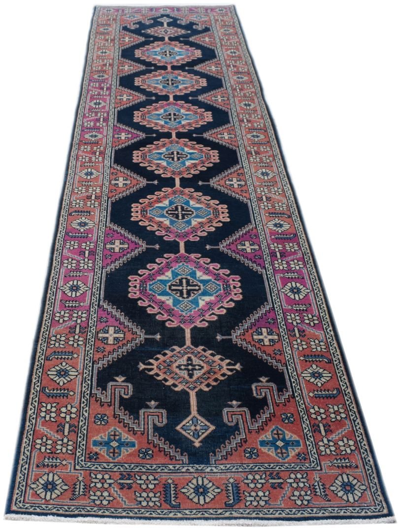 A vintage handmade Persian Hamadan runner featuring geometric medallions on a dark blue field.