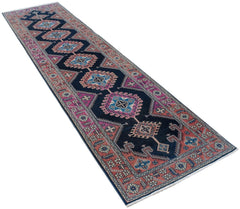 A vintage Persian Hamadan runner featuring a dark blue field with repeating geometric medallions.