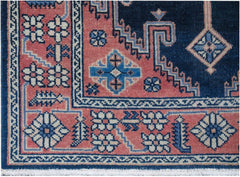 A vintage Persian Hamadan runner featuring a geometric floral pattern in navy and coral wool.